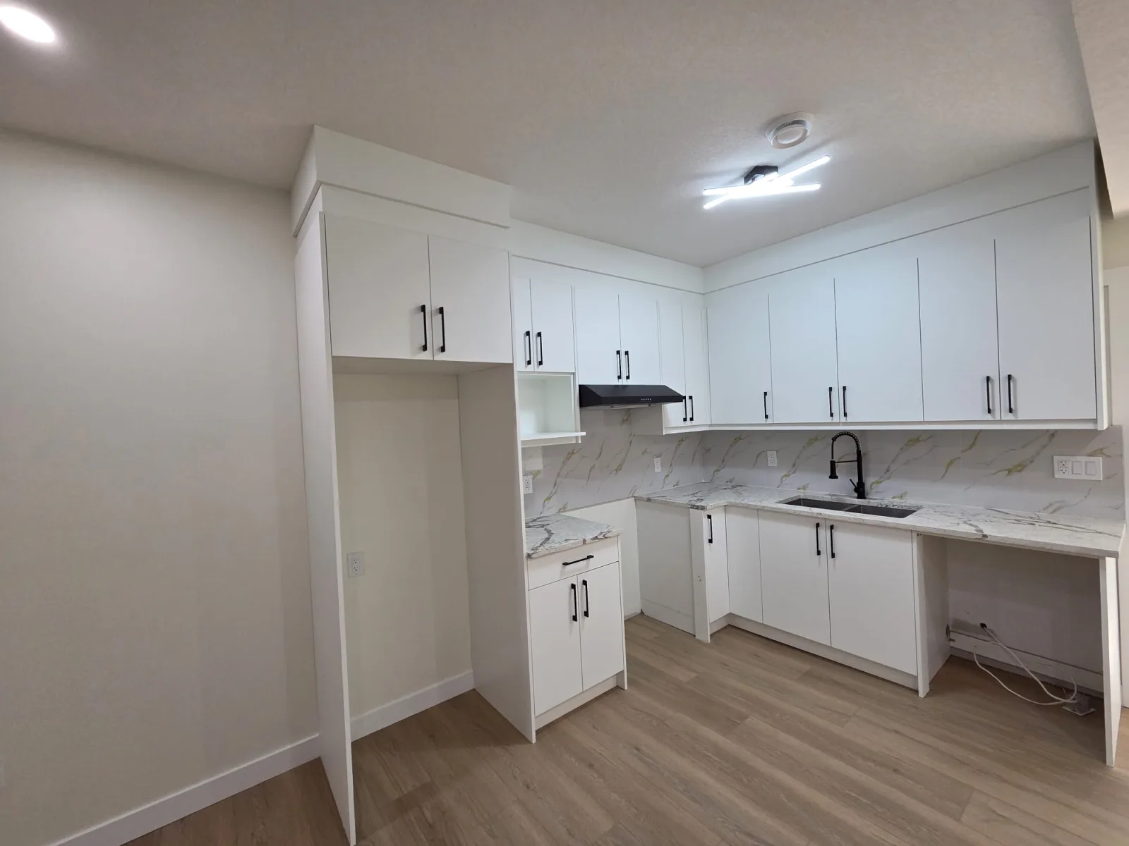 Finished basement recreation room with built-in shelving, Calgary