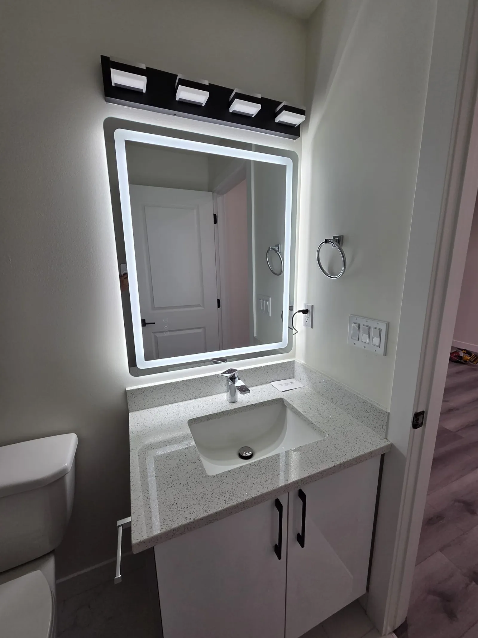 Basement suite kitchen with white cabinetry and quartz island, Calgary