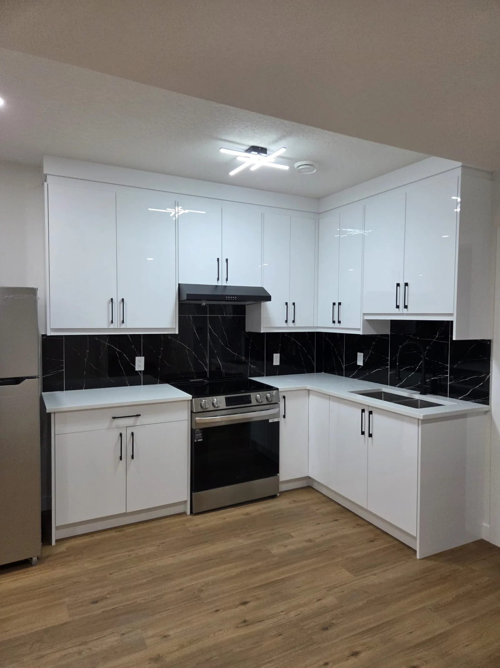 Before-and-after kitchen renovation with dark cabinetry, Calgary